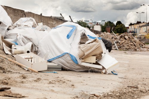 Workers loading cubic-yard amount of mixed commercial waste into a van